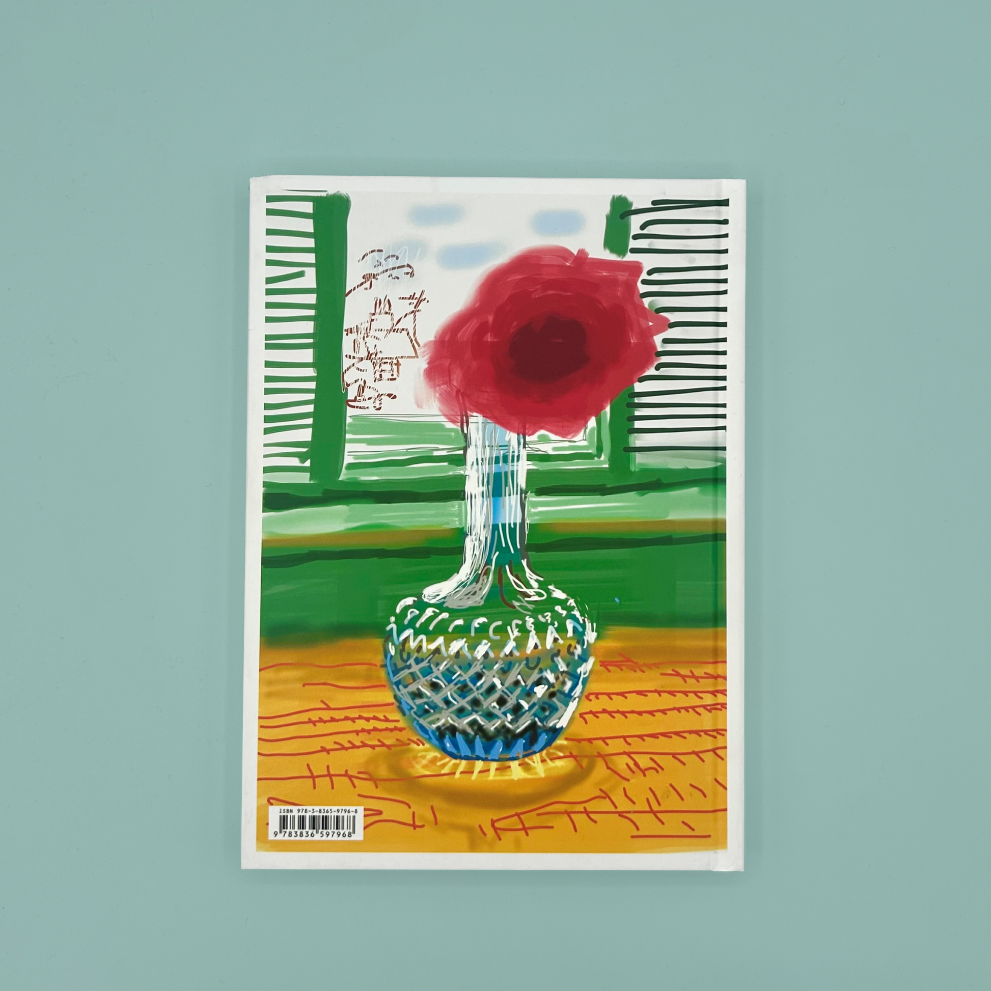 The back cove rof 'My Window' which has an illustration of a red flower in a glass vase on a colorful background