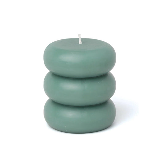 A blue pillar candle with a curvy shape.