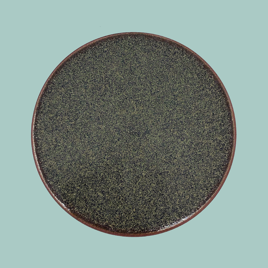 Round coaster on a blue background.