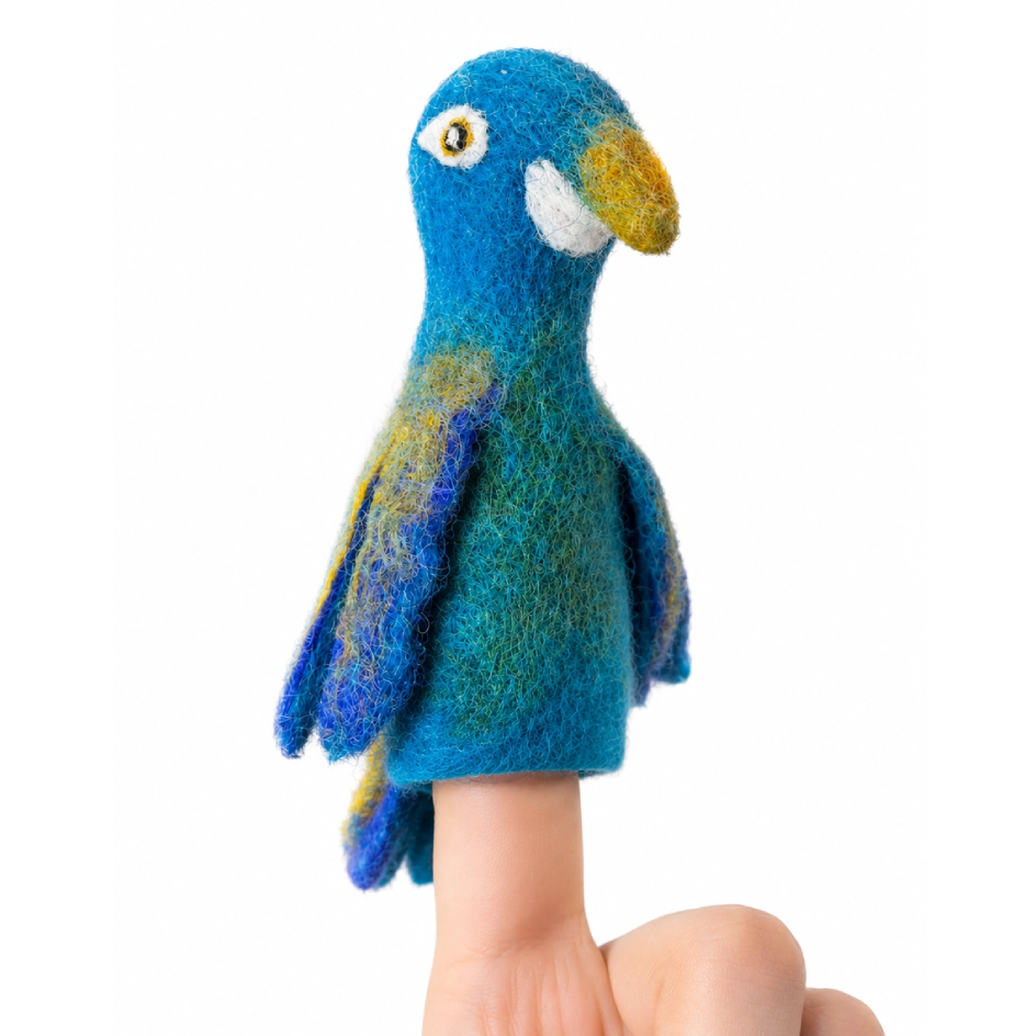 A felted wool parrot finger puppet on a finger, featuring vibrant blue, green, and yellow feathers, a white cheek patch, and a yellow beak, set against a plain white background.