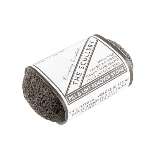 Grey pill and lint remover wrapped in a paper sleeve on a plain white background