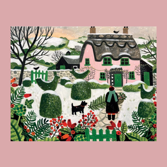 A folk-art style winter village scene with a pink cottage, snow-covered ground, bare trees, green hedges, and a person standing with a dog in the foreground. The artwork is centered on a muted pink background.
