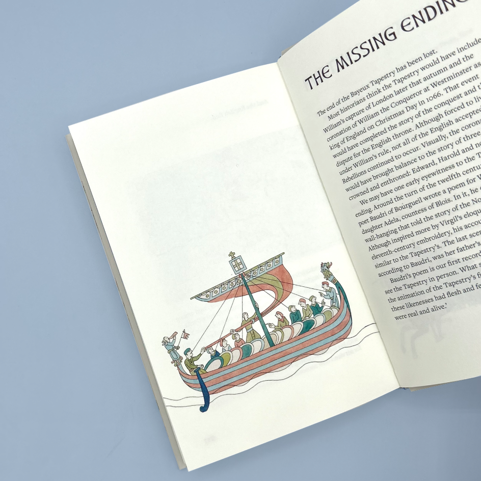 An open book spread showing a page with text titled 'THE MISSING ENDING' and an illustration of a Viking longship carrying people, photographed against a light blue background.