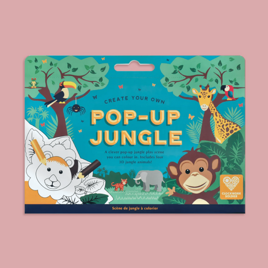 A children's pop-up jungle colouring set, featuring colorful cartoon animal illustrations including a giraffe, monkey, elephant, toucan, and lion on a blue jungle-themed cover, shown against a solid pink background.