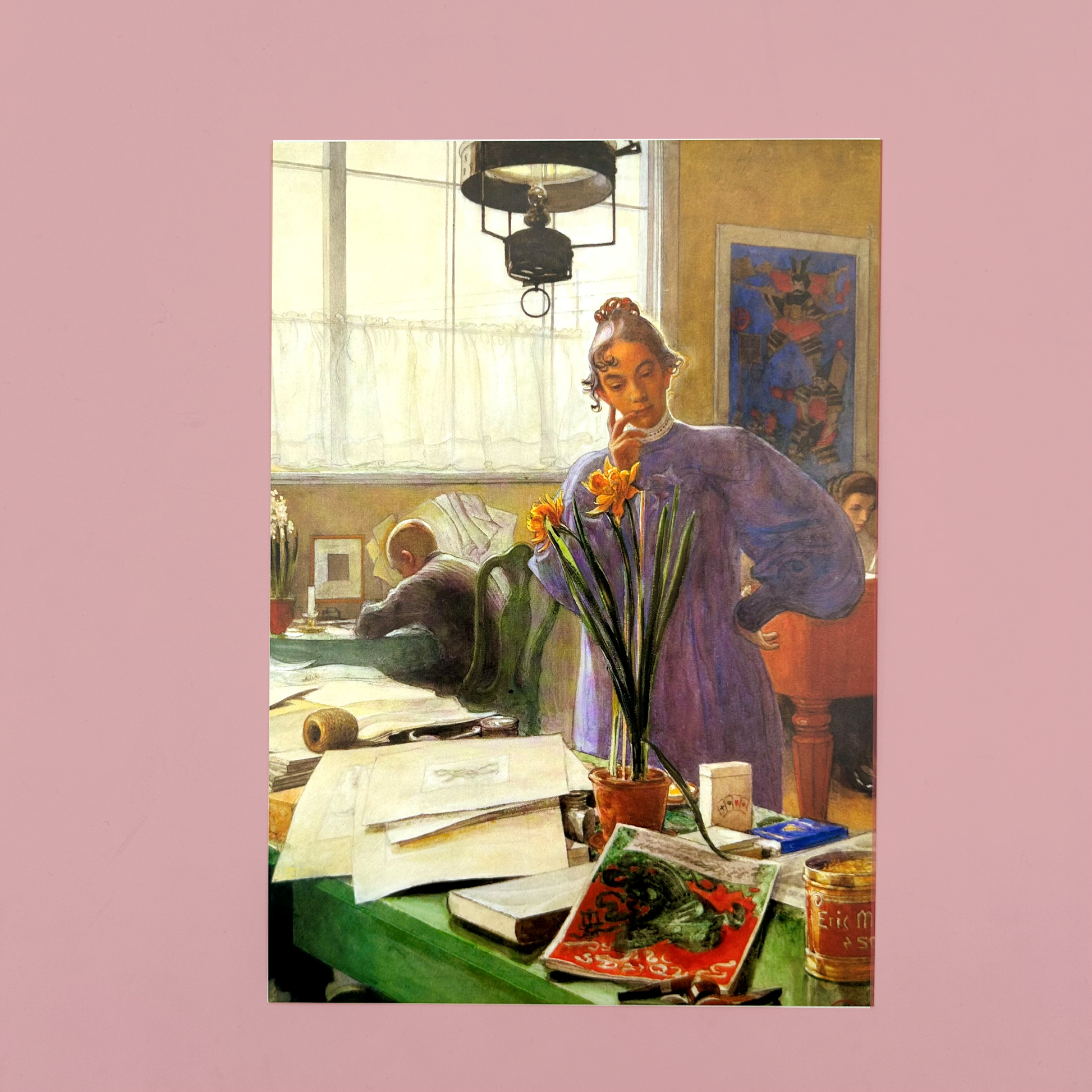 Postacrds of a painting of a woman in a room with a desk and various items, holding a flower.