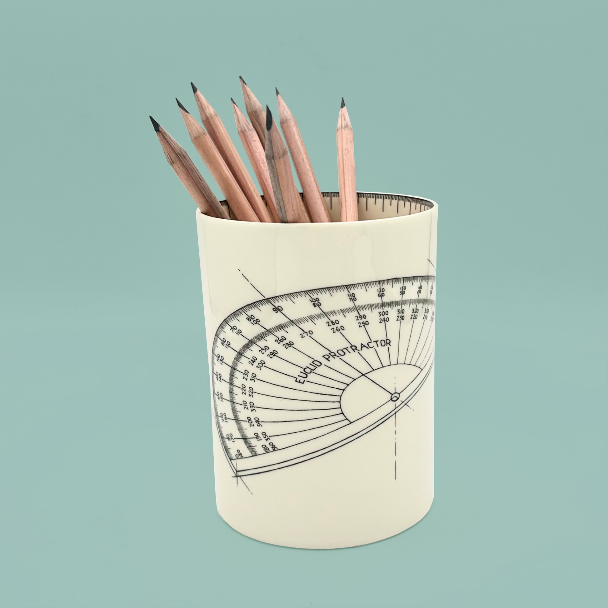 Pencil holder with protractor design containing pencils on a light blue background