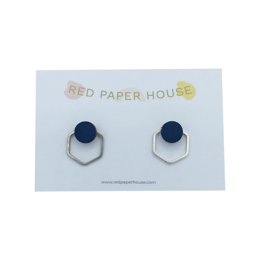 Navy blue earrings with silver hexagonal posts on a Red Paper House branded card.