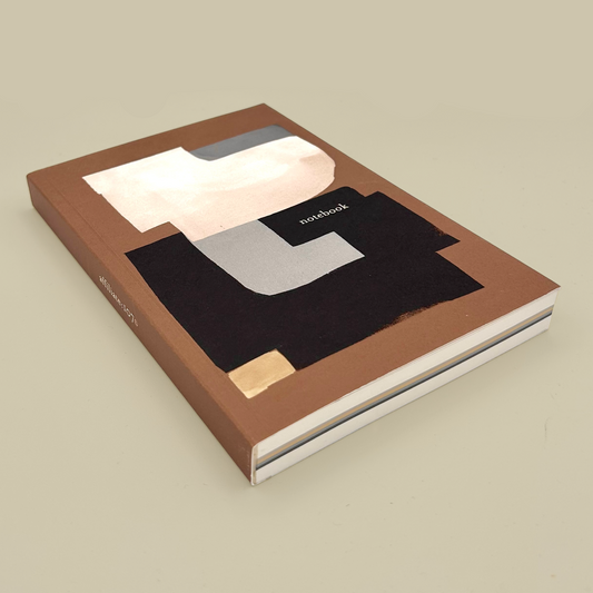 Notebook with a brown cover featuring abstract shapes on a beige background