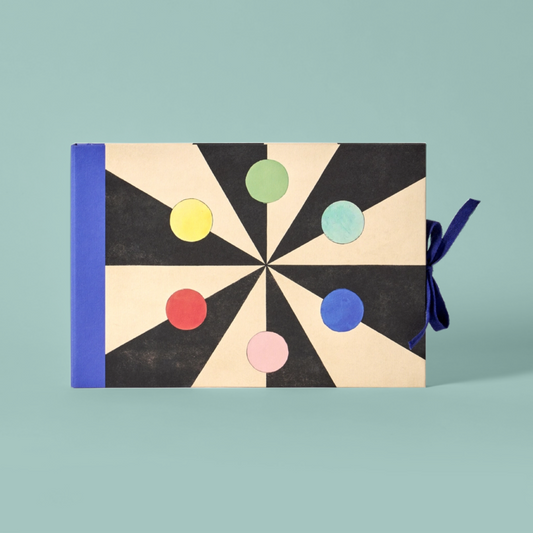 Book with a geometric design featuring colorful circles on a black and white background