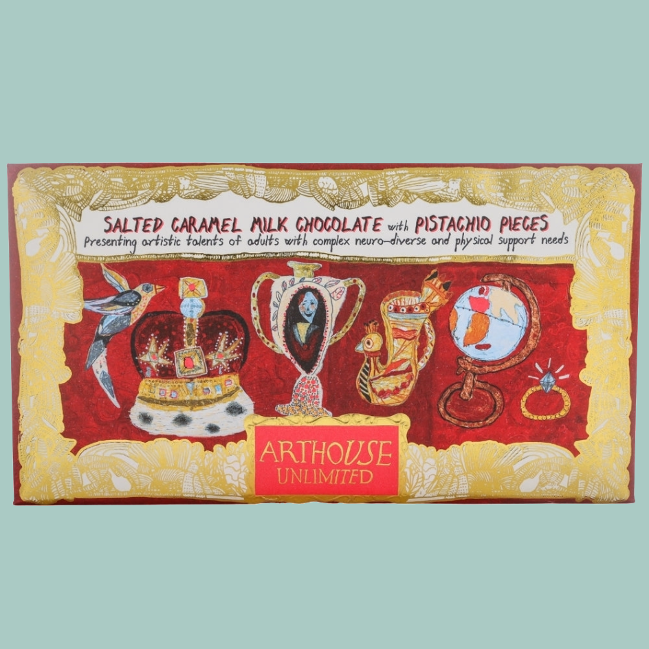 A rectangular chocolate bar package labeled 'Salted Caramel Milk Chocolate with Pistachio Pieces' by Arthouse Unlimited, featuring a red and gold illustrated design with whimsical objects on the front.