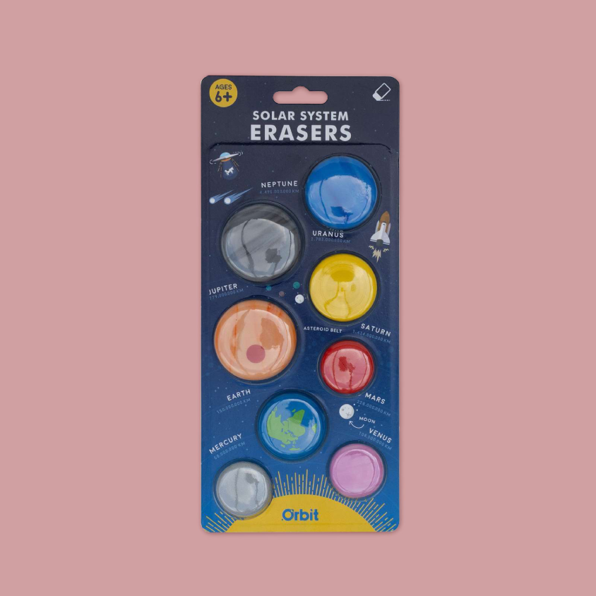 Orbit Solar System Erasers toy set in its original packaging, featuring eight colourful erasers representing the planets of the solar system on a dark blue backing card against a solid pink background.