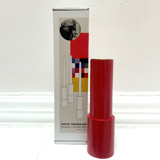 Red candle stick holder with a white box. 
