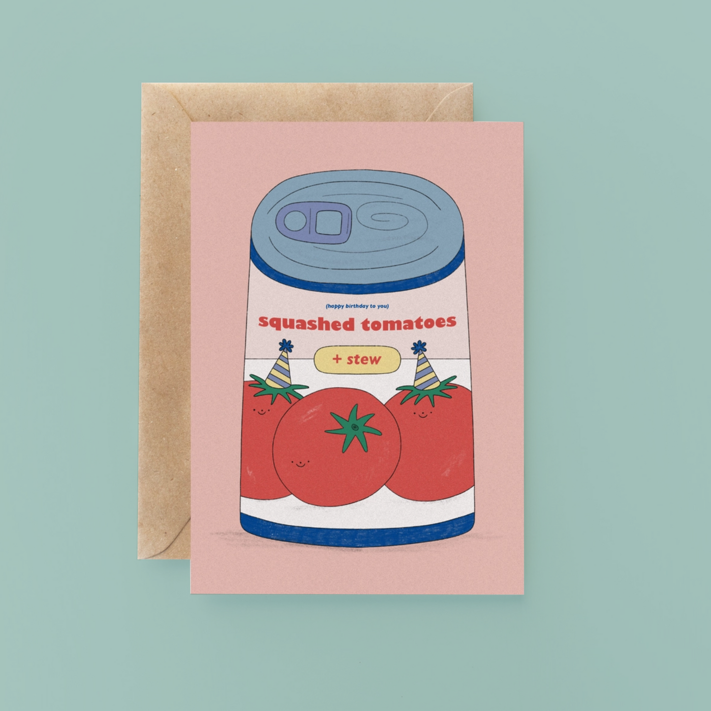Greeting card with a can of 'Squashed Tomatoes + Stew' design on a pink background, with a brown envelope.
