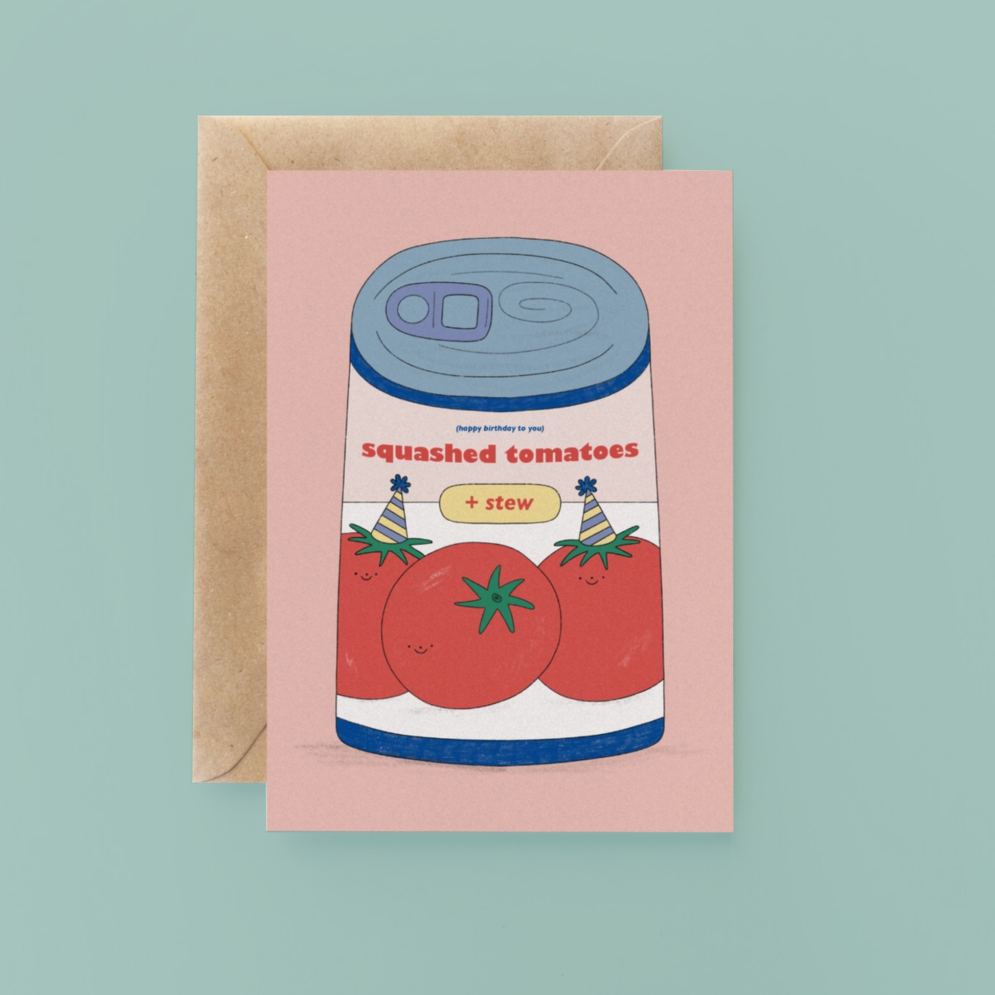 Greeting card with a can of 'Squashed Tomatoes + Stew' design on a pink background, with a brown envelope.