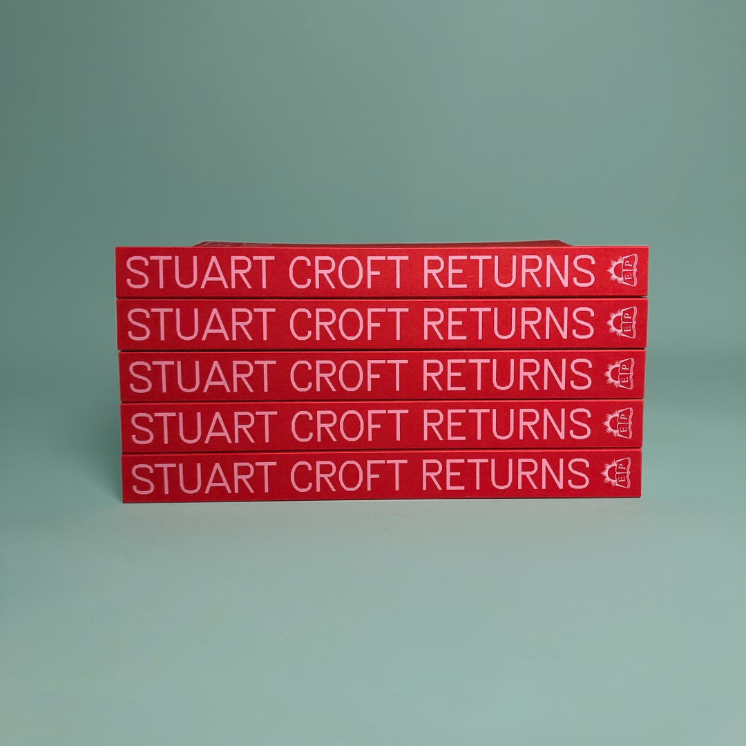 A stack of red books with 'STUART CROFT RETURNS' on the spine in pink text.