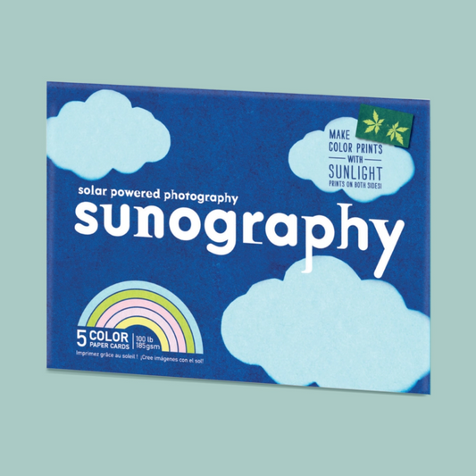 Sunography solar powered photography paper packaging with blue background and cloud designs.