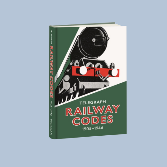 Front cover of 'Telegraph Railway Codes' which has a graphic illustration of a steam train, a green background, and red text. The book is on a blue backdrop.