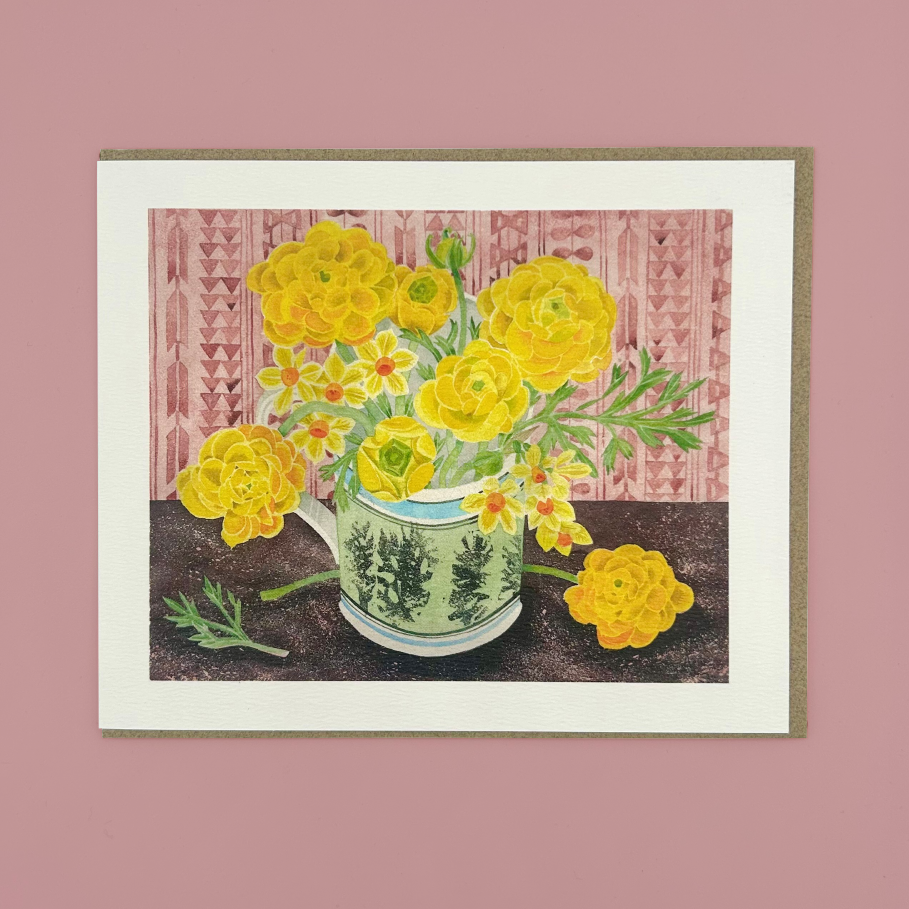 Greetings card that has a mug with yellow flowers, on a pink background.