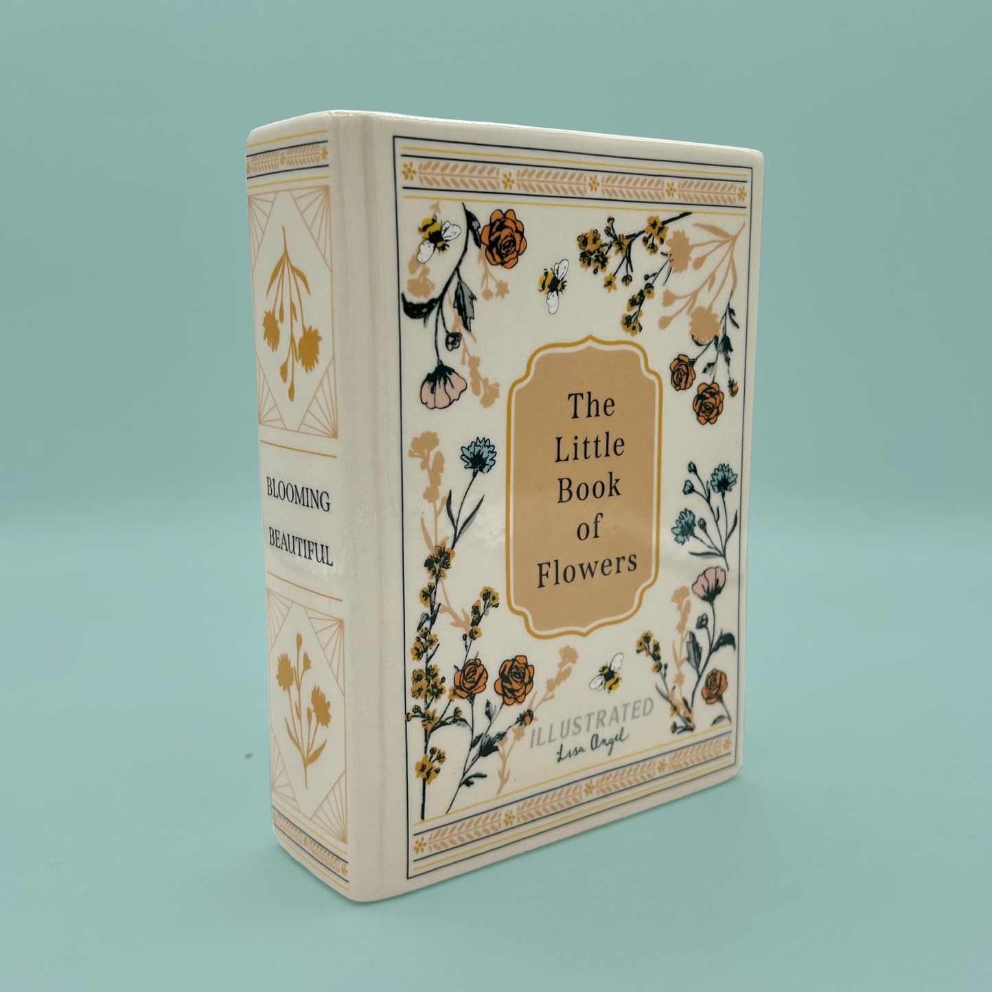 Book vase with text that reads 'The Little Book of Flowers' with floral illustrations on a light blue background