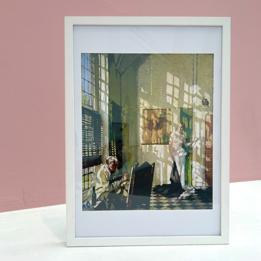 Framed artwork of a person painting a nude figure in an artists studio. 