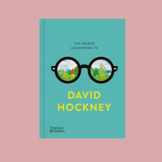Book cover of 'The World According to David Hockney' which has an illustration of a pair of glasses with scenic illustration inside the lenses on a blue base. The book is on a pink background.