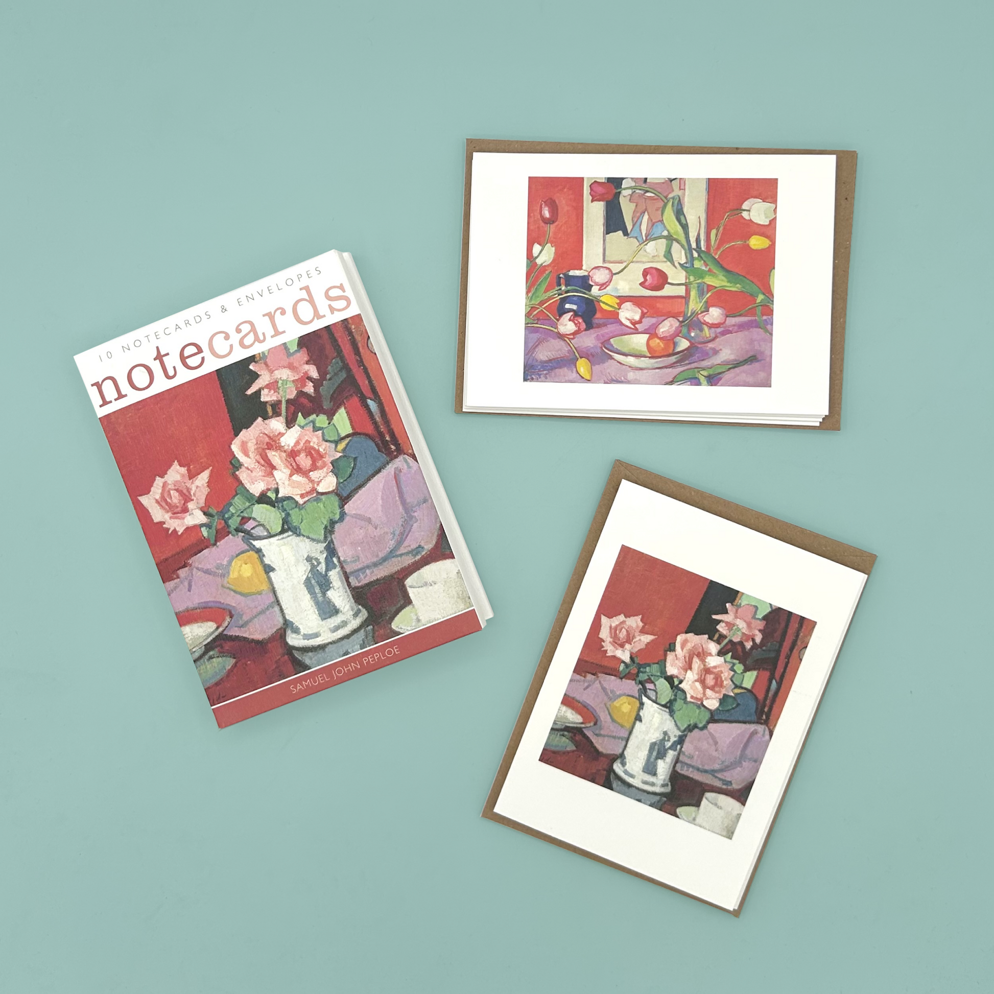 Set of note cards with floral designs on a teal background