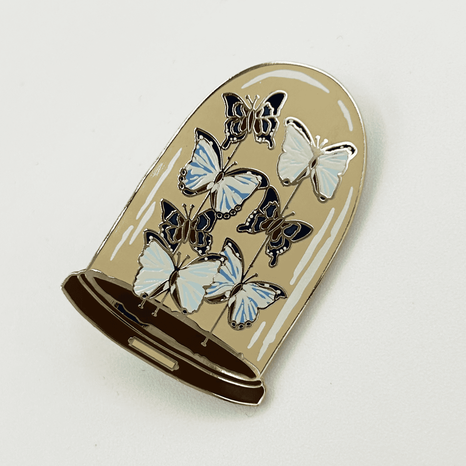 Butterfly dome pin badge on a white background.