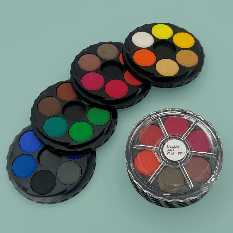 Set of water colour palettes on a light blue background