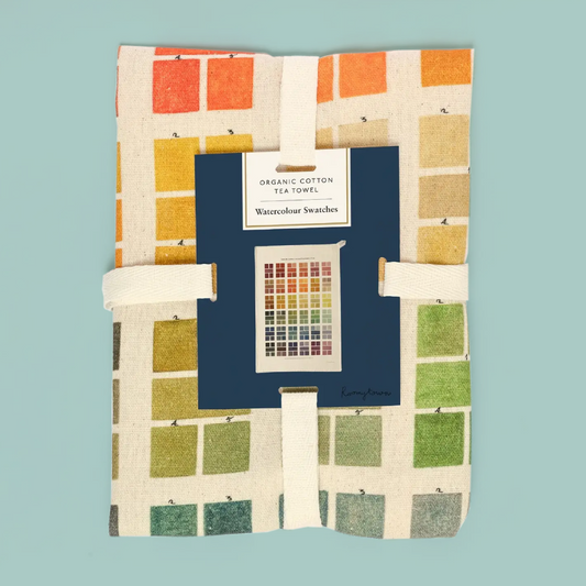 Tea towel with colorful pattern and brand label on a teal background