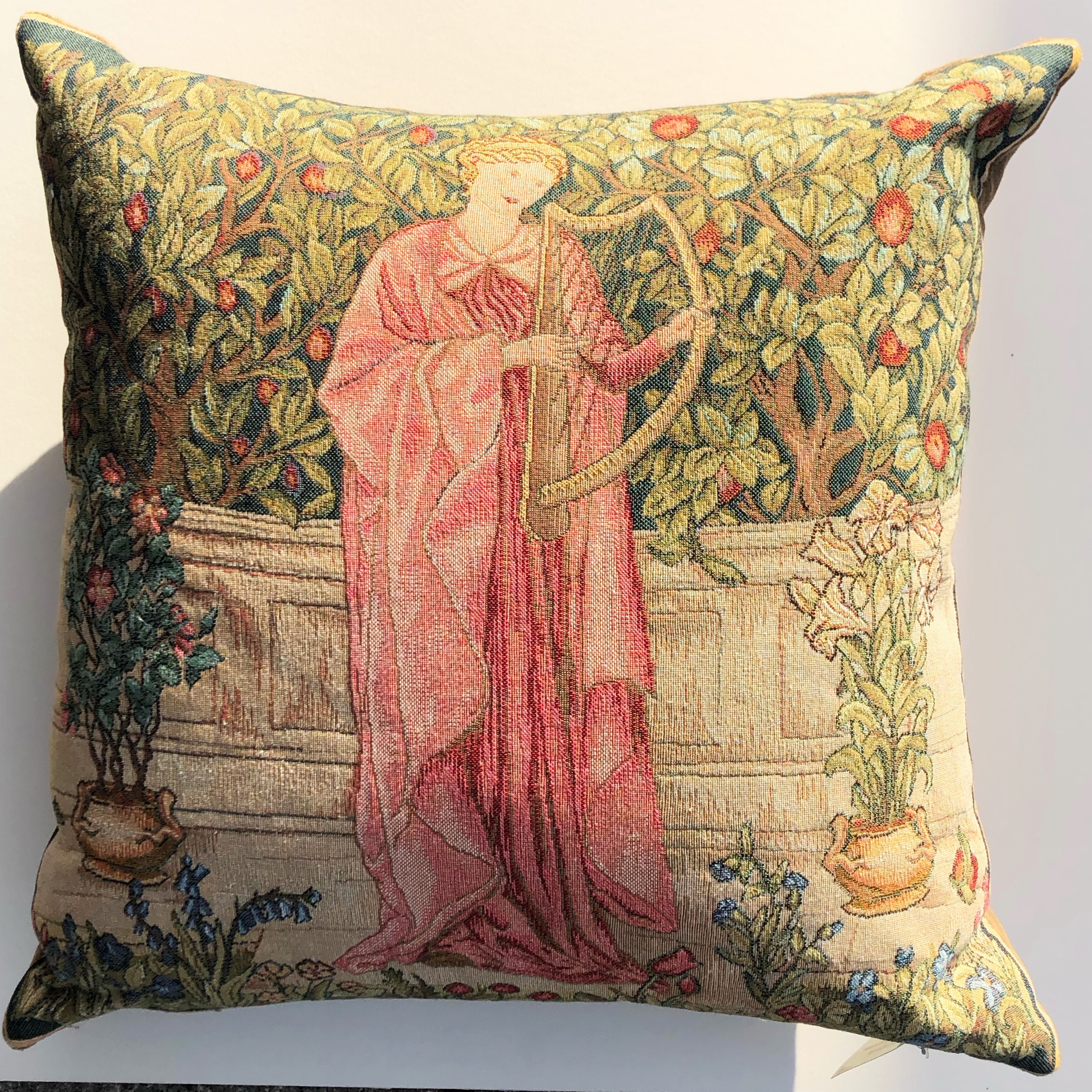 woven cushion of a medieval tapestry on a natural background
