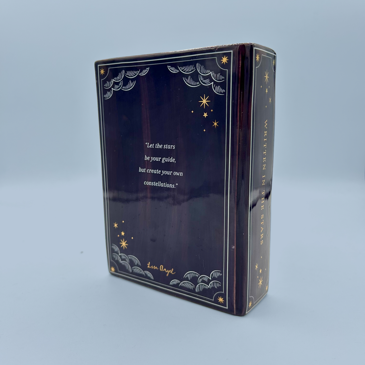 Decorative box vase with star and moon designs on a blue background