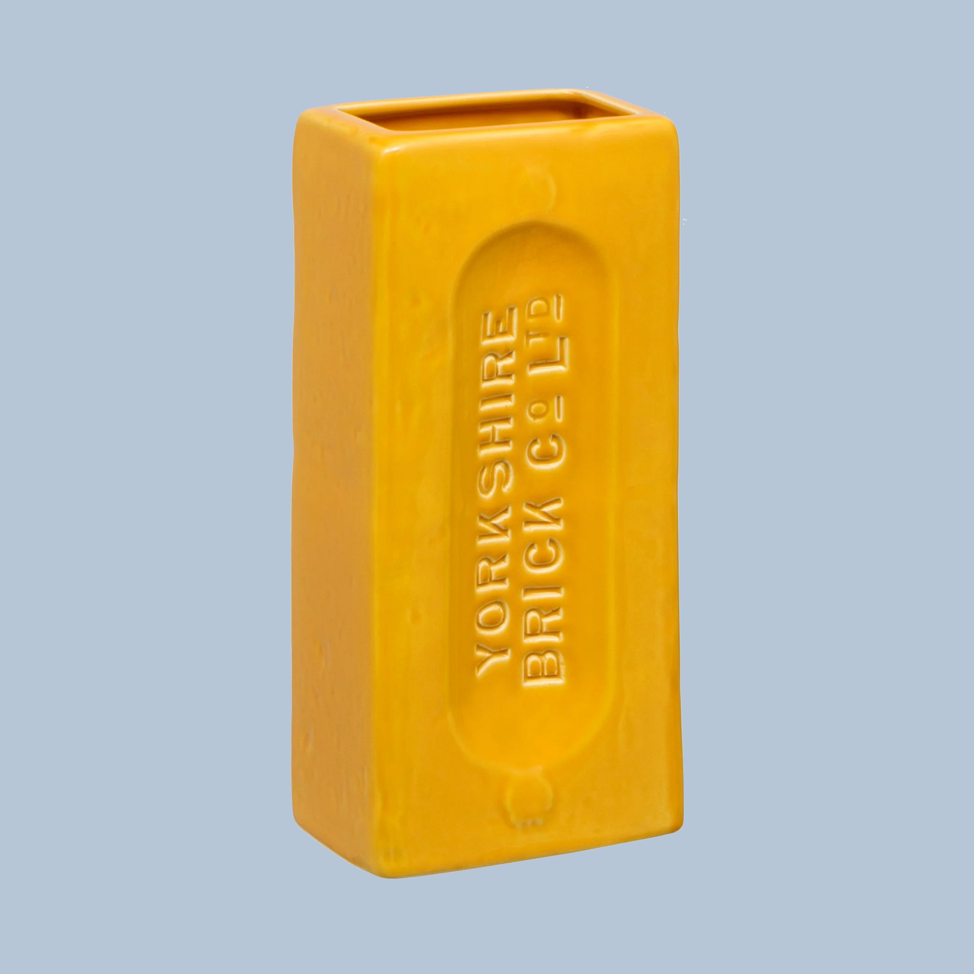 Yellow rectangular vase with 'Yorkshire Brick Co' branding on a light blue background